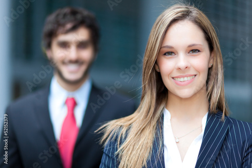 Photo: Two business people outdoor smiling Two business people outdoor smiling