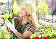 Photo: Woman working in garden center Woman working in garden center