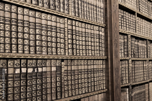 Photo: Old books ina library - sepia image Old books ina library - sepia image