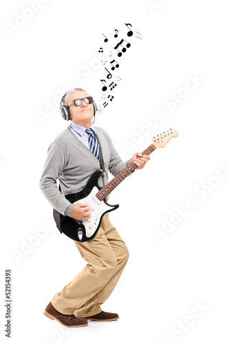 Photo: Middle aged man playing guitar and musical notes around Middle aged man playing guitar and musical notes around