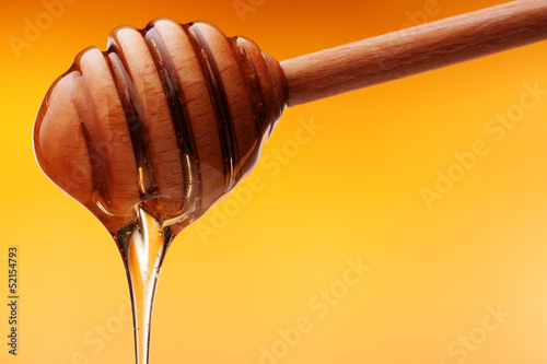 Photo: Honey dripping from a wooden honey Honey dripping from a wooden honey