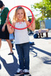 Girl In School Playground With Hoop