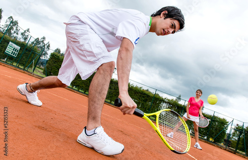 Photo: Couple playing tennis Couple playing tennis