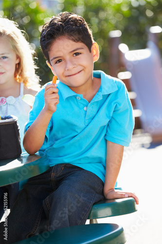 Photo: Elementary Pupil Sitting At Table Eating Lunch Elementary Pupil Sitting At Table Eating Lunch