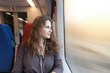 woman looks out the window