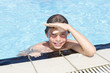 Activities on the pool. Cute boy swimming and playing in water i
