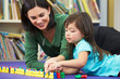 Elementary Pupil Counting With Teacher In Classroom
