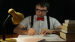 Crazy nerd man writing in home office at night