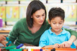 Elementary Pupil Counting With Teacher In Classroom