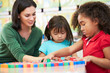 Elementary Pupils Counting With Teacher In Classroom