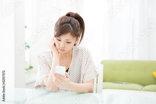 Photo: 部屋でスマホを使う女性 部屋でスマホを使う女性