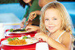 Elementary Pupils Enjoying Healthy Lunch In Cafeteria
