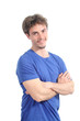 Young man smiling with his arms folded