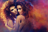 Couple of female friends hugging in dream scenery