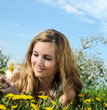 Young woman enjoying the spring between dandelions