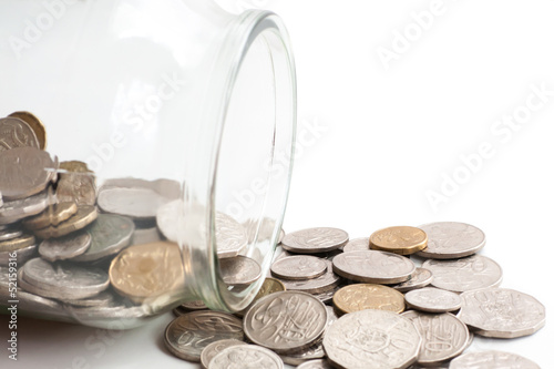 Photo: Australian coins spilling out of a glass jar Australian coins spilling out of a glass jar
