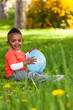 Outdoor portrait of a cute young  little black boy playing with