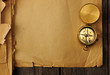 Antique brass compass over old background