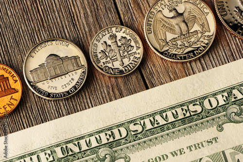Photo: US money over wooden background US money over wooden background