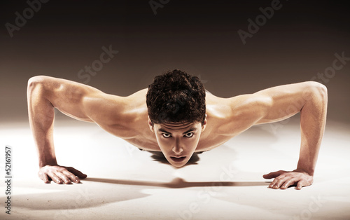 Photo: Muscular handsome guy with curly hair Muscular handsome guy with curly hair