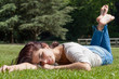 Photo: Young woman lying on grass Young woman lying on grass