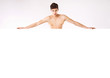 Photo: Muscular nude man behind big empty board Muscular nude man behind big empty board
