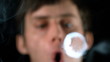 Man blowing smoke rings close up