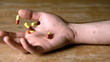 Mans hand falling holding pills after overdose