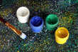 Jars with colorful gouache and brush