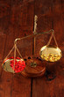 Photo: Classic scales with color pills on wooden background Classic scales with color pills on wooden background