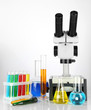 Test tubes with colorful liquids and microscope isolated