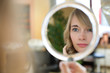 Client in hairdresser salon watches herself in mirror