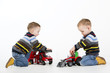 Foto: Twin brothers playing with toy fire engine and car Twin brothers playing with toy fire engine and car