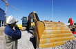 Photo: hardhat worker pointing at large bulldozer hardhat worker pointing at large bulldozer