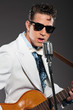 Retro rock and roll singer wearing white suit and black sunglass