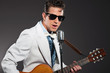 Retro rock and roll singer wearing white suit and black sunglass