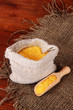 Grains in sack on wooden background