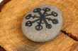 Fortune telling  with symbols on stone on wooden background