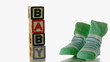 Green slippers falling besides baby blocks