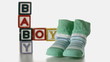 Slippers falling besides baby blocks on white background