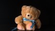 Cute teddy bear falling on black background