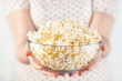 Girl holding a glass bowl of popcorn