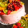Fruit cake with cream coating and fruits