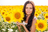 Beautiful young woman on the sunflowers field