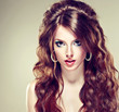 Beautiful brunette girl. Long curly brown hair