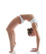 Foto: Sporty girl doing gymnastic bridge in studio Sporty girl doing gymnastic bridge in studio