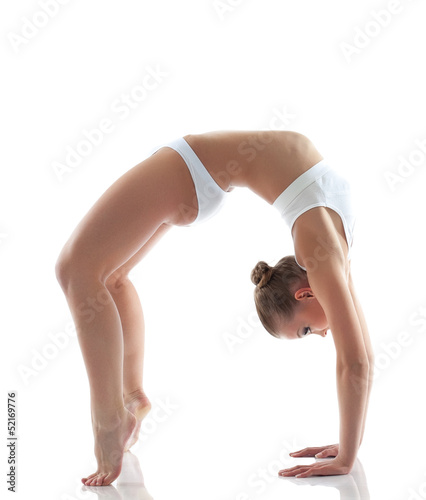 Photo: Sporty girl doing gymnastic bridge in studio Sporty girl doing gymnastic bridge in studio