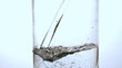 Water pouring into glass close up