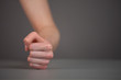 Female fist hits on the table.