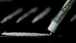 Someone snorting a line of cocaine with other lines in background